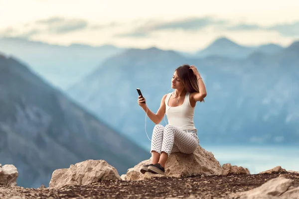 Young Caucasian Female Listening Music Phone Enjoying Nature Montenegro — стоковое фото