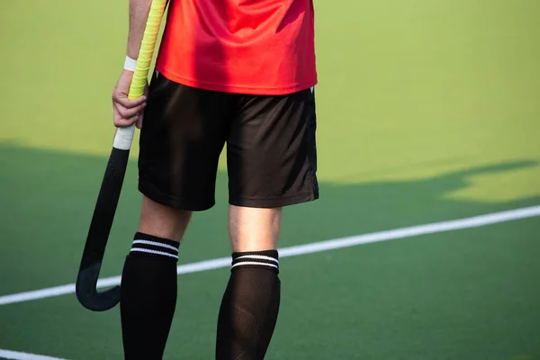 Close-up on a professional field hockey player.