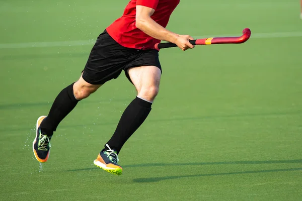 Close-up on a professional field hockey player.