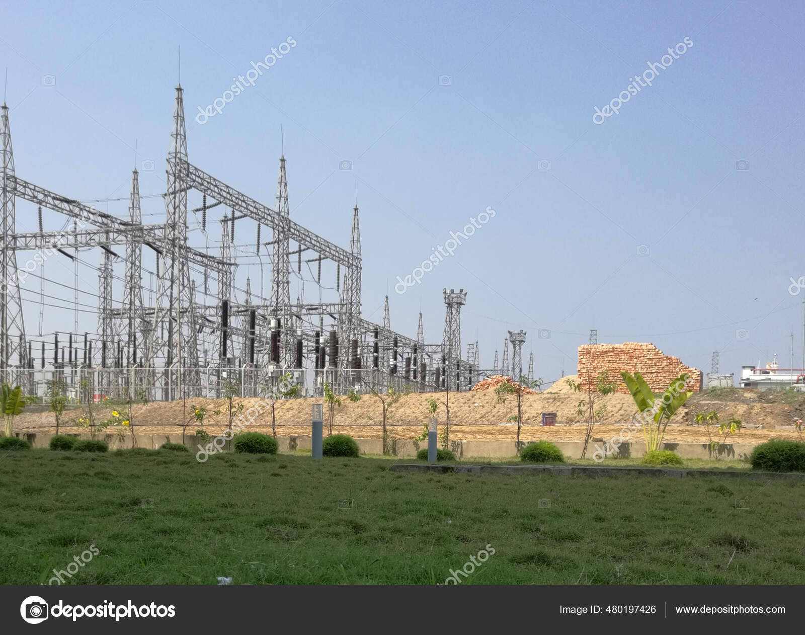 Green Meadow Background Huge Transmission Towers Stock Photo by