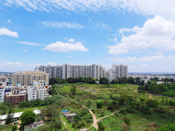 A cityscape with high buildings and green space