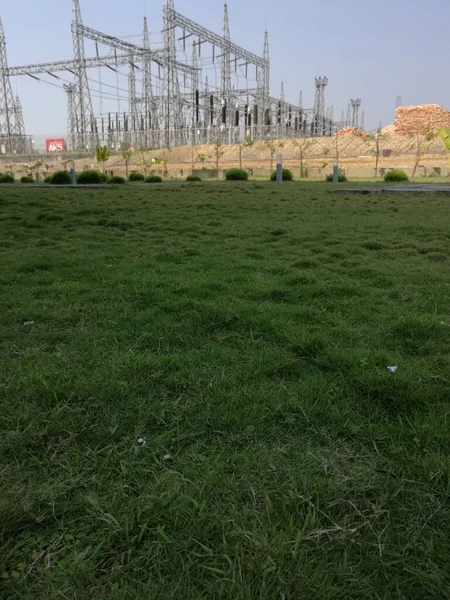 Vertical Shot Green Meadow Background Huge Transmission Towers — Stock Photo, Image