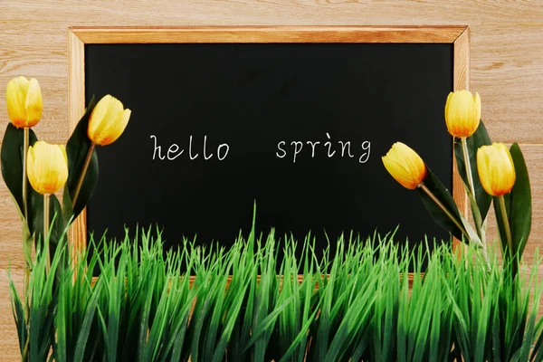 Blackboard Hello Spring Text Yellow Tulips Wooden Surface — Stock Photo, Image