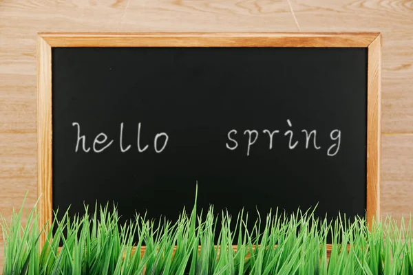 Blackboard Hello Spring Text Green Grass Wooden Surface — Stock Photo, Image