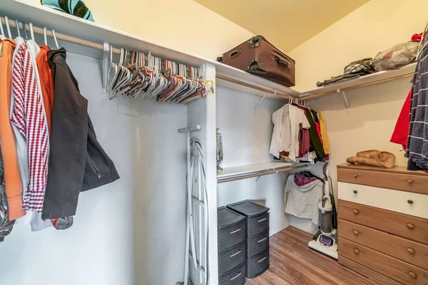 the doorless wardrobes and closets in a white room