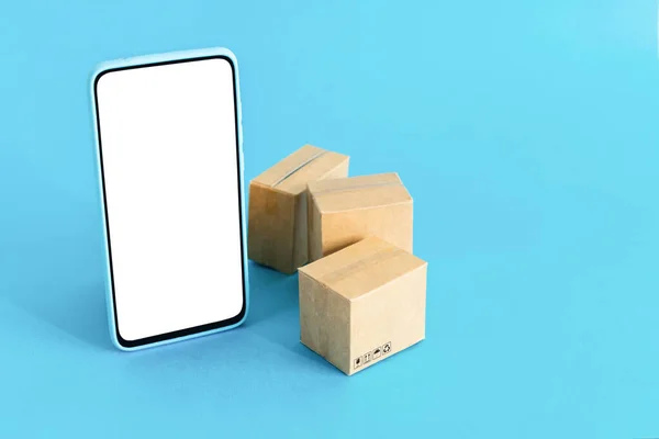 Smartphone Blank Screen Cardboard Boxes Isolated Light Blue Background — Stock Photo, Image