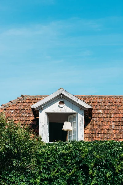 ポルトガルのカスカイスに開いた窓を持つ白い屋根裏部屋の垂直ショット — ストック写真