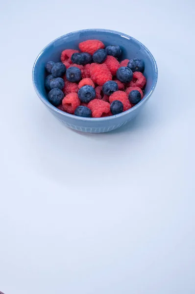 Vertical Shot Fresh Blueberries Raspberries Bowl Isolated Blue Background — Stock Photo, Image