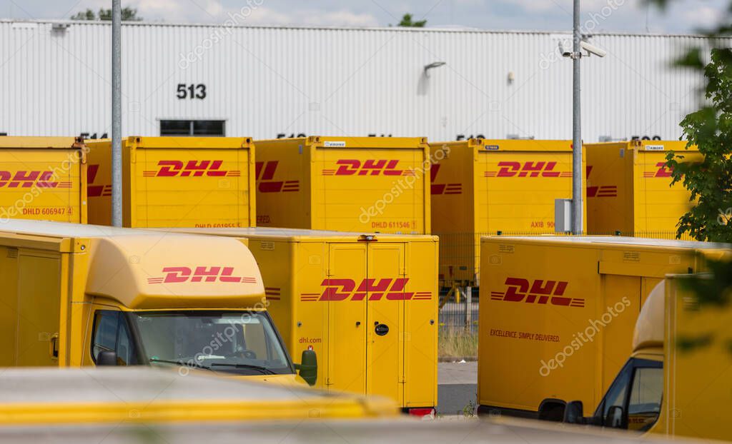 NEUWIED, GERMANY - Jun 18, 2021: Neuwied, Germany - June 20, 2021: DHL delivery vans and containers in front of a DHL depot