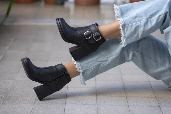 A closeup shot of a woman wearing boots outdoors