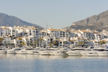 MARBELLA, SPAIN - Jan 21, 2021: Puerto Banus, luxury marina, port in Nueva Andalucia, with yachts, La Concha mountain behind, Marbella, Costa del sol, Andalucia, Spain. clipart