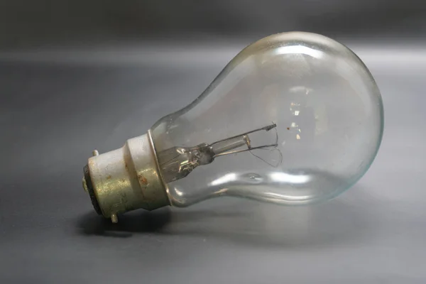 Closeup Incandescent Light Bulb Grey Surface — Stock Photo, Image