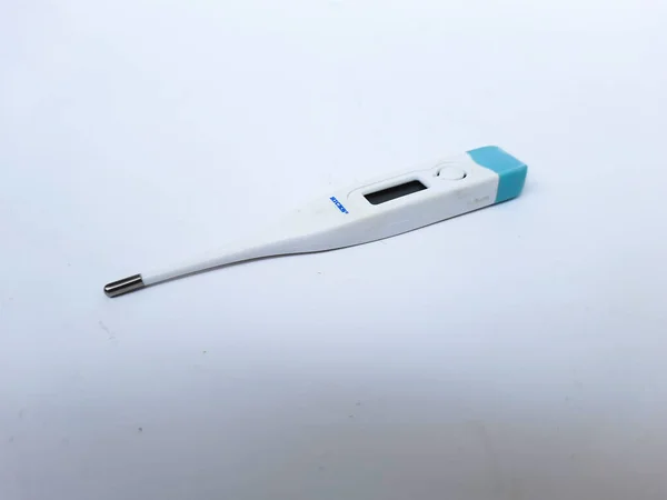 A white digital thermometer on a white surface