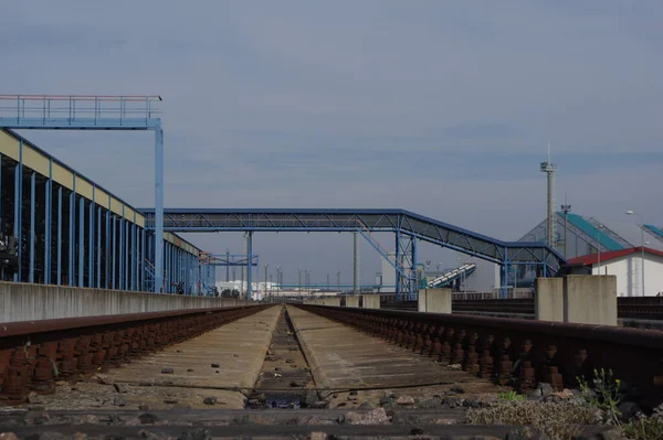 Oude Treinrails Omgeven Door Een Fabriek Onder Een Blauwe Bewolkte — Stockfoto