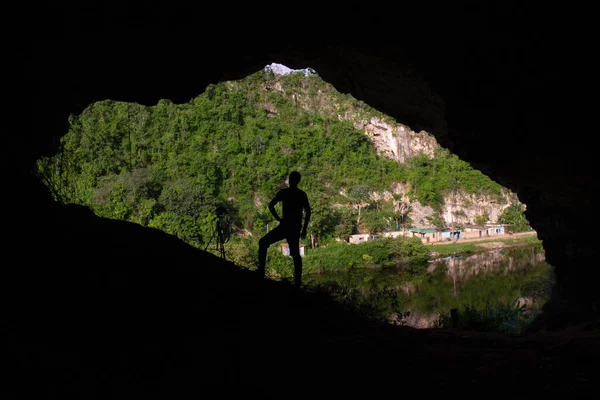 Silhouette View Hispanic Man Standing Dark Cave Looking Green Hills — Stock Photo, Image