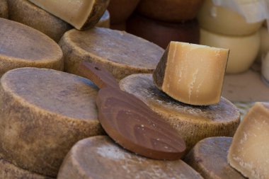A selective focus shot of majorero cheese and a wooden utensil clipart