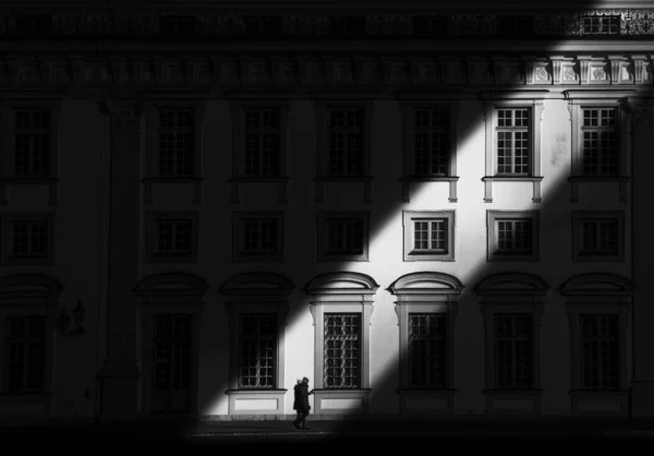 Grayscale Shot Man Walking Dark City Building Narrow Light — Stock Photo, Image