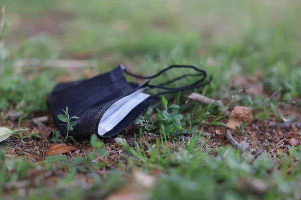 Closeup Shot Black Face Mask Grass Environmental Pollution Covid Pandemic — Stock Photo, Image