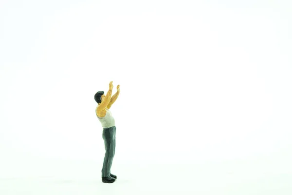 Closeup Shot Small Human Figure Toy Its Hands Isolated Background — Stock Photo, Image