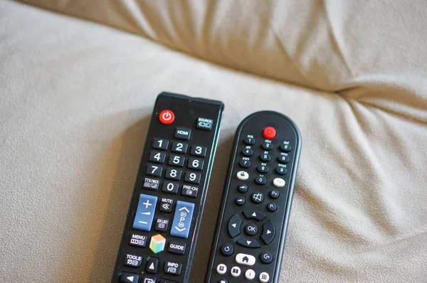 Dua Televisi Hitam Plastik Remote Sofa — Stok Foto