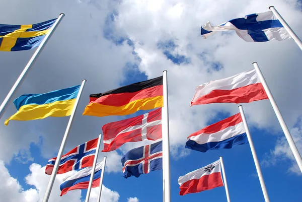 Low Angle Shot Many Flags Winding Air Cloudy Sky — Stock Photo, Image