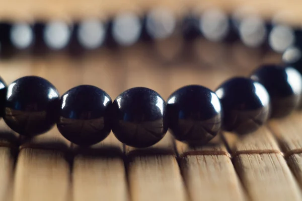 Closeup Shot Black Stone Bead Bracelet Wooden Table — Stock Photo, Image