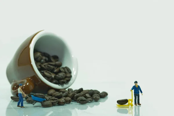 Overturned Espresso Coffee Cup Filled Coffee Beans Miniature Workers Transport — Φωτογραφία Αρχείου