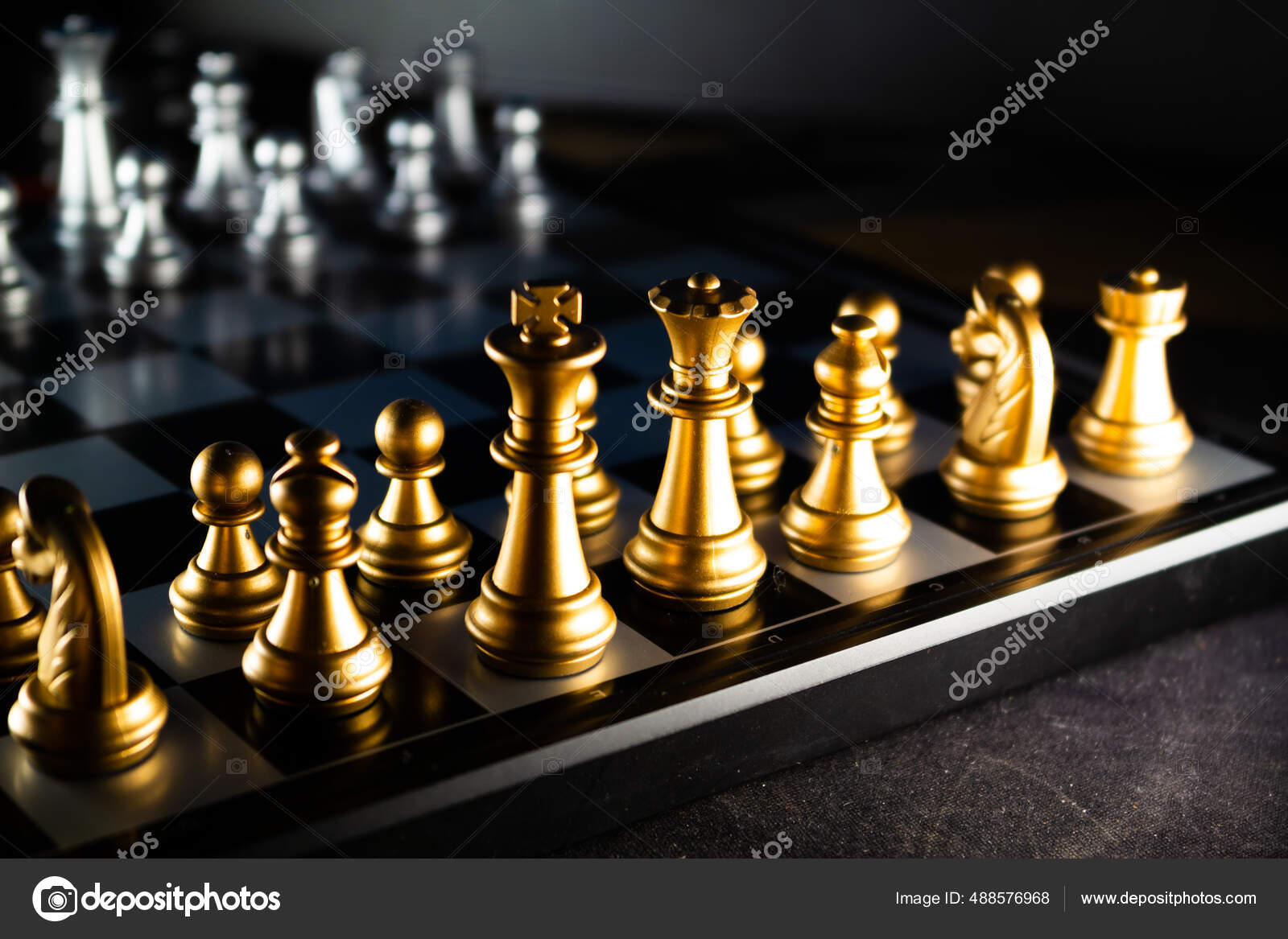 Horizontal shot of cool silver chess pieces in the starting position  reflected on the board Stock Photo by wirestock