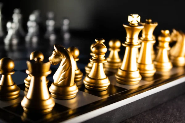 Horizontal shot of cool silver chess pieces in the starting position  reflected on the board Stock Photo by wirestock