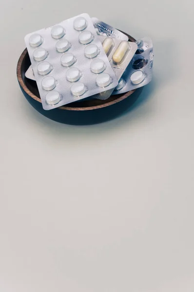 一组药丸泡包在一个与米色背景隔离的碗里 — 图库照片