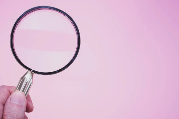 Hand Holding Magnifying Glass Pink Background — Stock Photo, Image