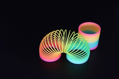 A high angle shot of rainbow colourful helical toy for children and adults clipart