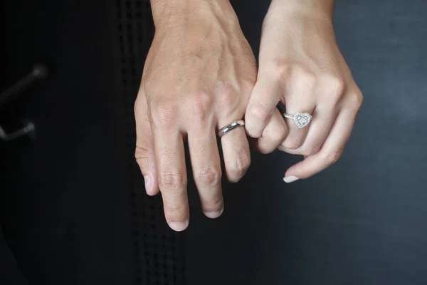 Closeup Image Male Female Hands Silver Rings Holding Fingers Black — Zdjęcie stockowe