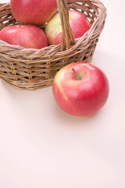 Vertical Shot Red Apples Wicker Basket Isolated Light Pink Background — Stock Photo, Image