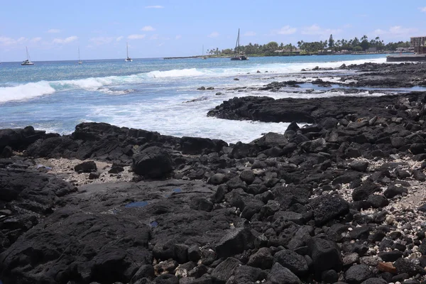 The oceanside landscape of black volcanic rock on the island of Kona, Hawaii