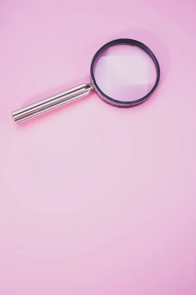 Vertical Shot Magnifying Glass Isolated Pink Background Copy Space — Stockfoto