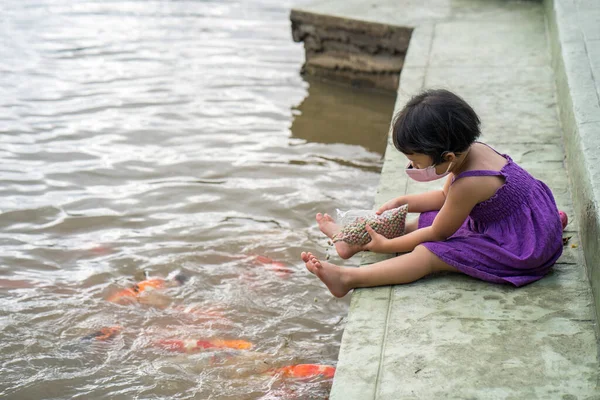 Ein Süßes Asiatisches Kleines Mädchen Einer Gesichtsmaske Füttert Fische Einem — Stockfoto