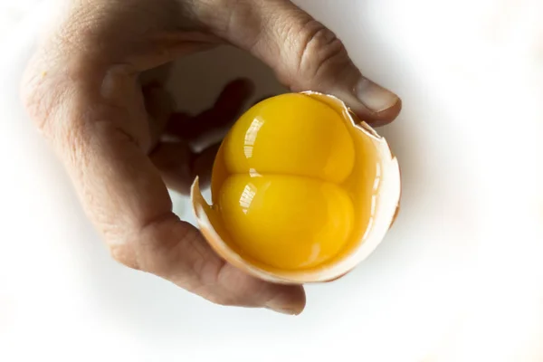 卵黄二個分の生卵を持つ者 — ストック写真