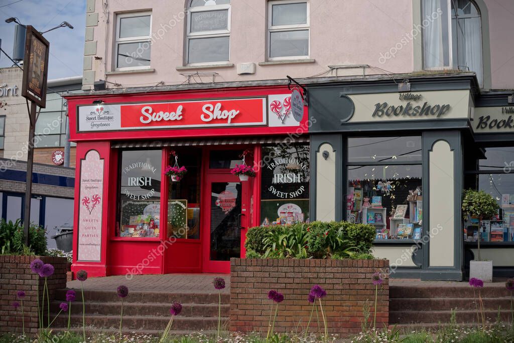 GREYSTONES, IRELAND - Jun 07, 2021: Local Irish shops, the Sweet Boutique and the Village Bookshop, in Greystones town, County Wicklow, Ireland.