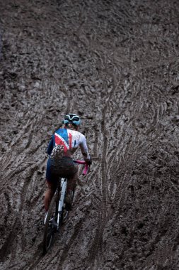 British cyclocross rider finding her way thorugh the mud at a cyclocross world cup. clipart