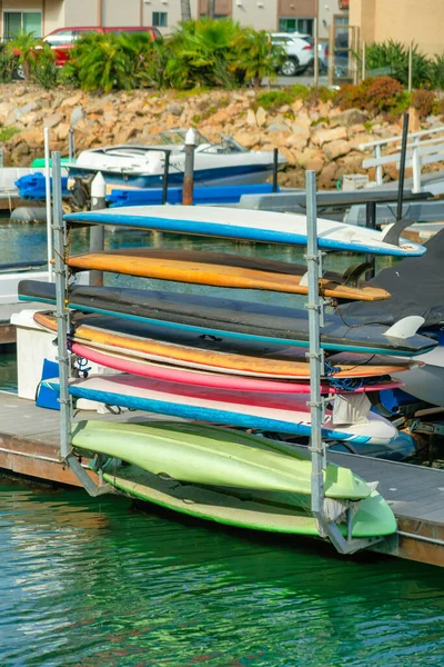 A row of surfboard on a metal rack