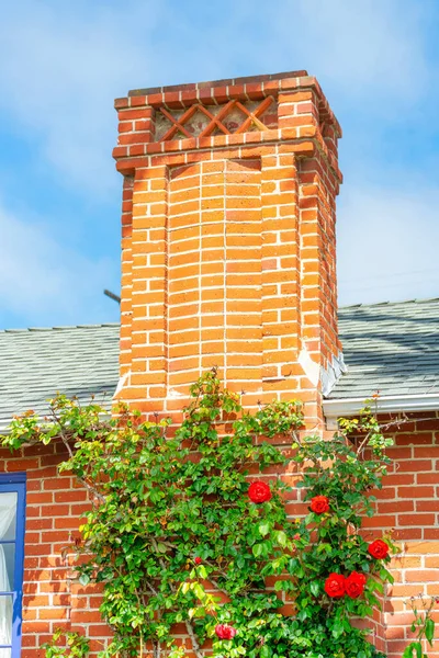 Vertical Shot Brick Chimney House Tile Roof Roses Its Wall — Stock Photo, Image