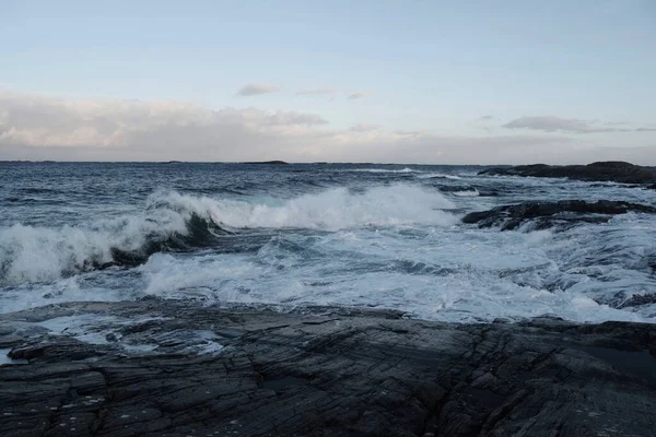 stock image A mesmerizing view of the waves splashing on the rocks in Norway