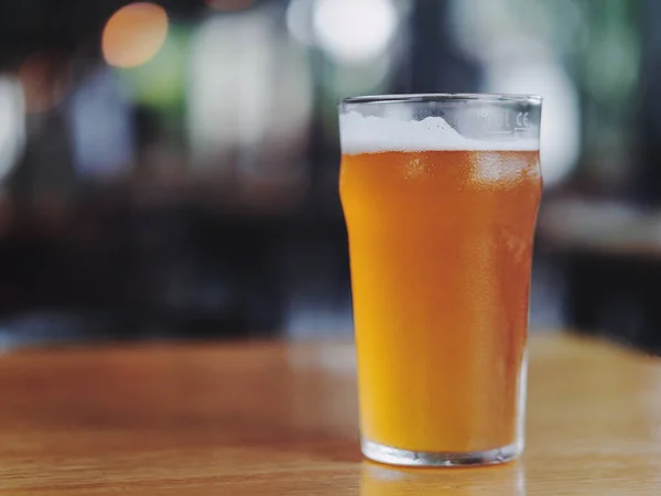 A closeup shot of a glass of beer on blurred background
