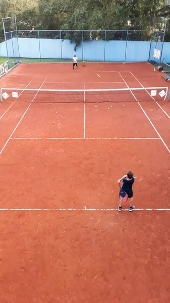 VOLTA REDONDA, BRAZIL - Jun 01, 2021: A boy playing tennis on a clay court.