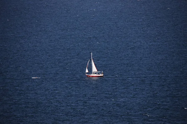 青い海に一隻の小型帆船 — ストック写真