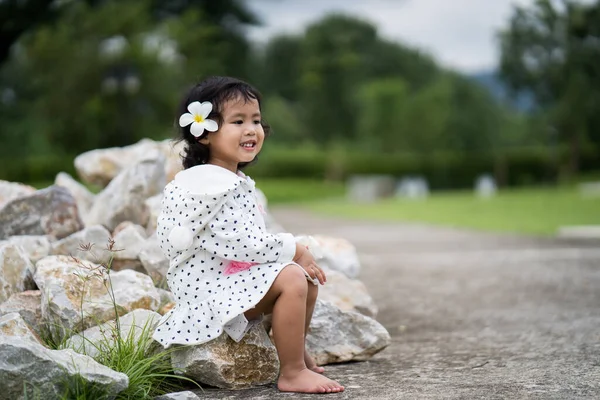 Маленькая Тайская Девочка Плюмерией Волосах Сидящая Камне — стоковое фото