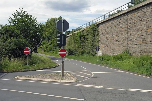 Girmeyin Işaretleriyle Yüksek Tuğla Duvarın Yanında Bir Viraj Yolu — Stok fotoğraf