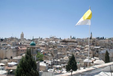 View over the roofs of Jerusalem old town with a white and yellow Hospiz flag hoisted clipart