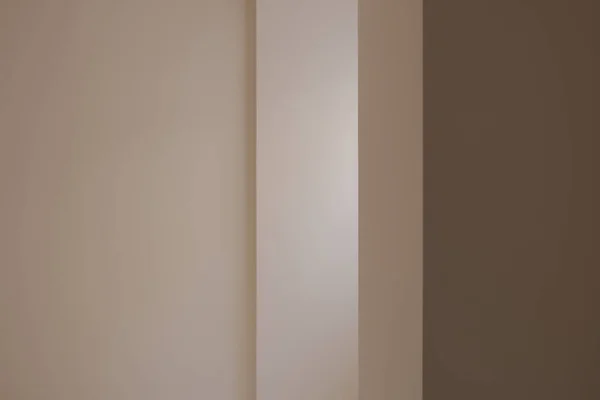 An interior design of an apartment beige wall edge under the light